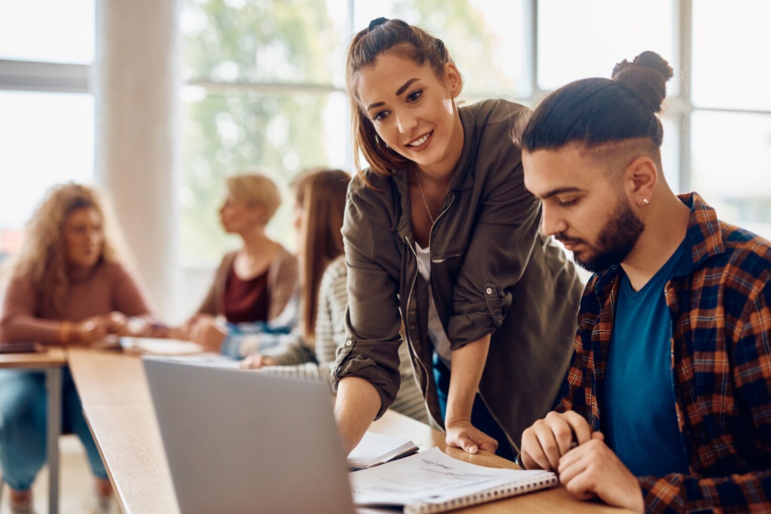 Lernende arbeiten gemeinsam am Laptop